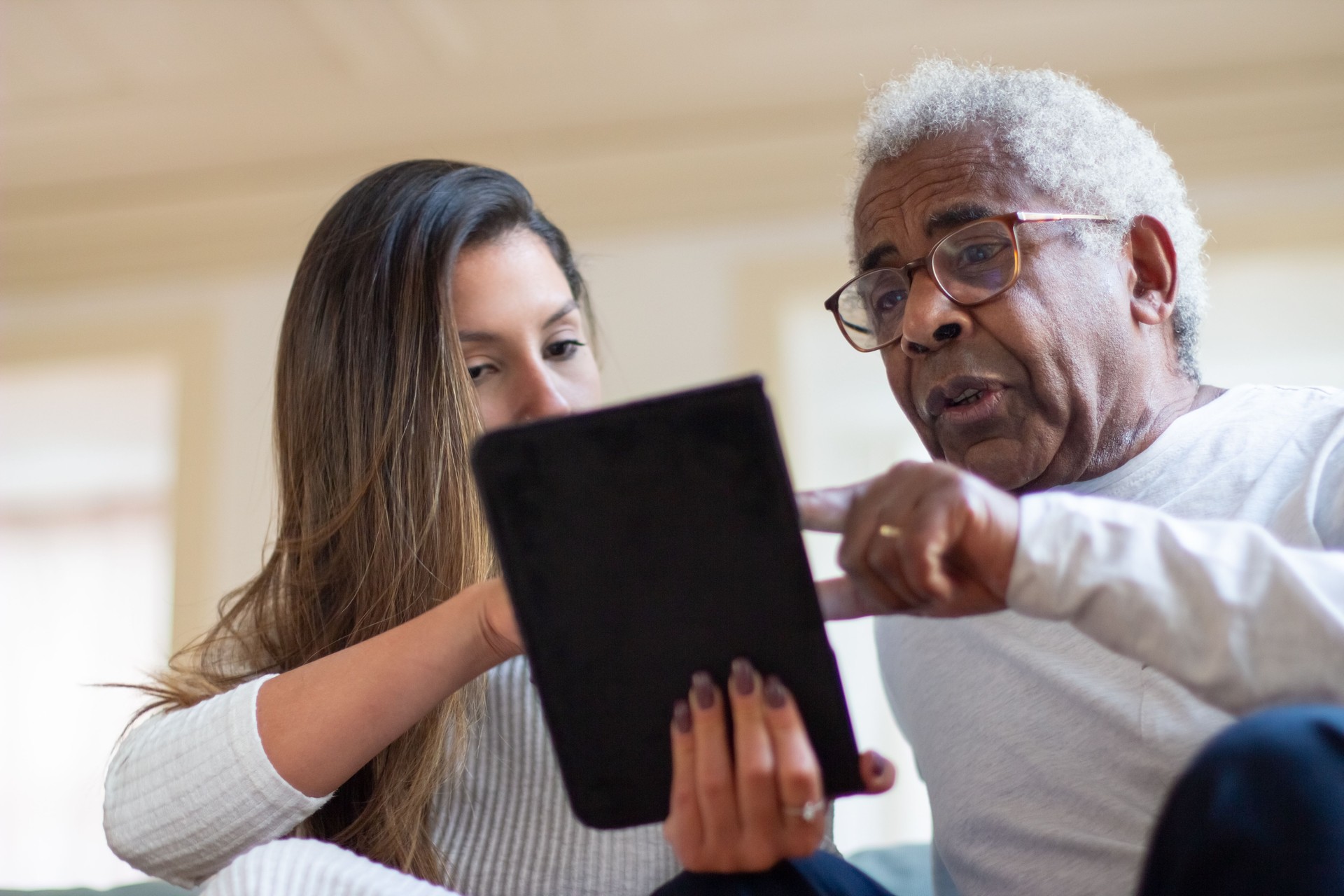 Close-up of aged calgary man and daughter with digital tablet