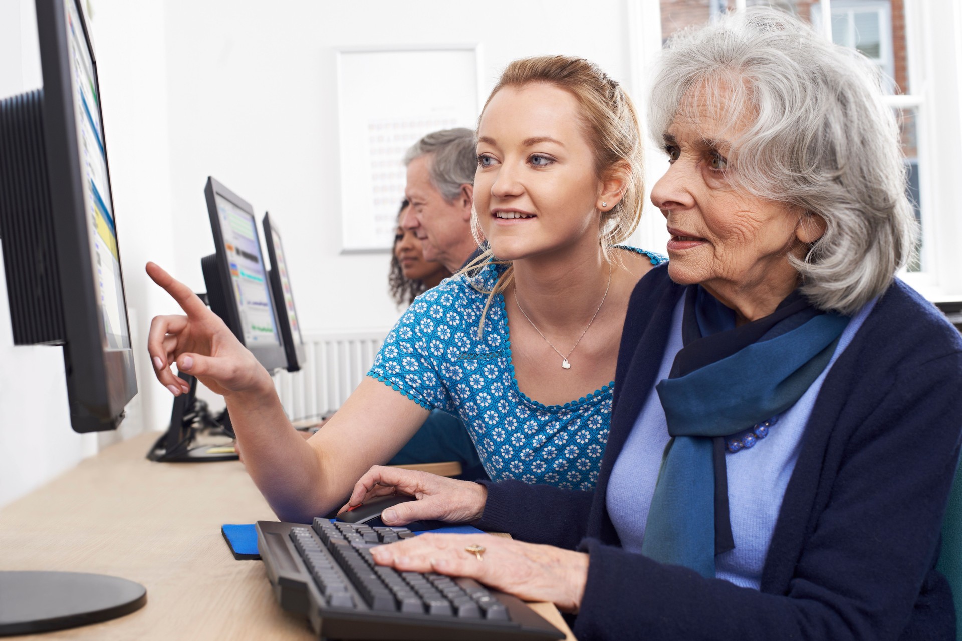 Calgary Tutor Helping Senior Woman In Computer Class